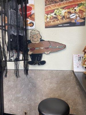 Tubby peers out from behind Halloween decor