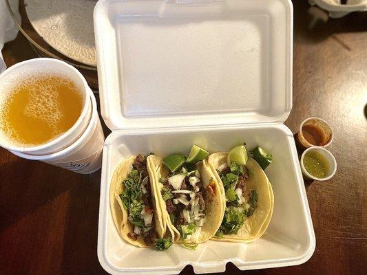 Steak tacos with passion fruit juice.