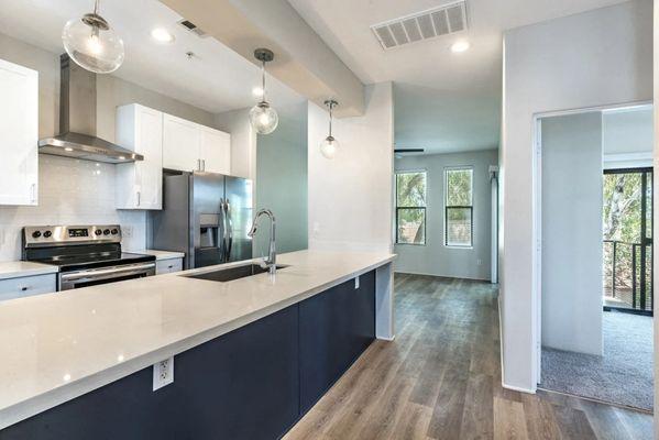 A Fully Furnished Kitchen with a breakfast bar with white counter
