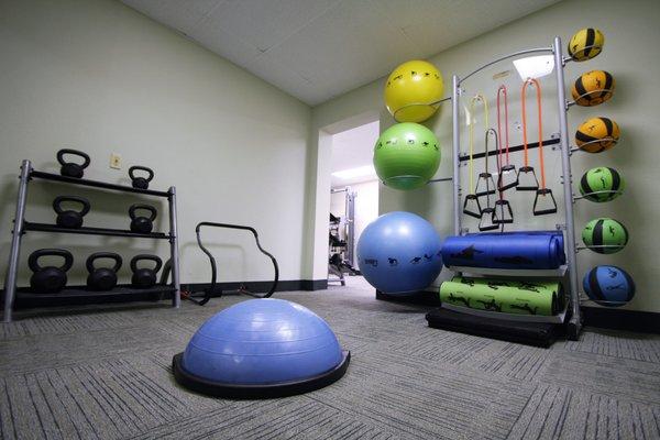 24-hour fitness center with free weights, kettle bells, resistance bands, cardio machines, and weight machines