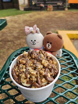 Small açai bowl... the granola and Nutella are covering the sliced bananas, etc