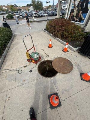 Sewer was clogged in the man hole cleared it and made sure pedestrians are safe