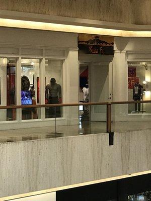 The front of the shop upper level across from the tree