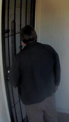 John trying to open my front door.