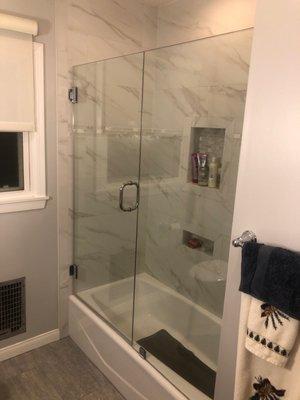 Frameless shower glass looks much cleaner than the old metal framed sliding glass doors over a shower/bath.