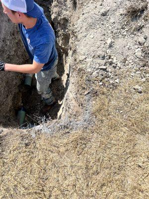 Removing a large stick jammed in a sewer line.