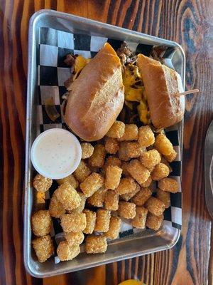 Tri-tip Sandwich with sautéed onions and mushrooms, tots on the side.