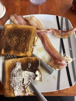 The bacon came out raw, black toast as hard as a rock. The coffee was cold.