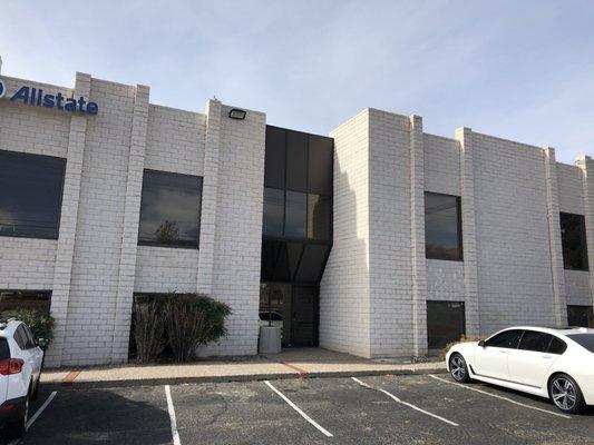 Building with entrance facing Wyoming. We're downstairs on right.