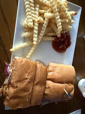 Dried Philly chicken sandwich with half frozen fries.