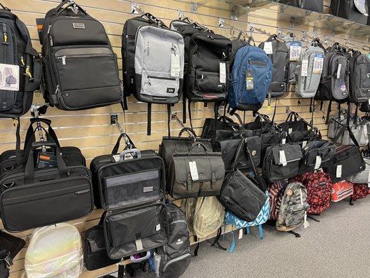 Lots of backpacks and tote bags