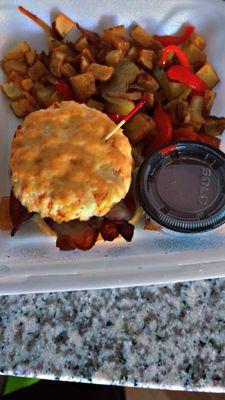 Bacon and Swiss cheese biscuit with home fries.