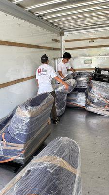 Guys load our furniture in the truck