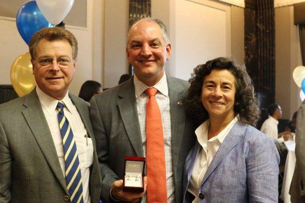 Wayne and Alice Madere with Governor John Bel Edwards holding the custom made cuff links his cabinet commissioned for his birthday.