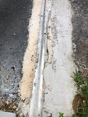 Cement work on asphalt driveway.