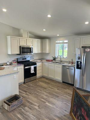 02-22-25 New Magnus Granite Countertop with White Lance Cabinets at Serenity Homes. Stainless Steel Appliances Throughout.
