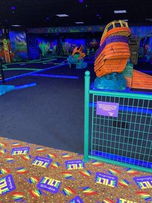 Indoor black light golf course