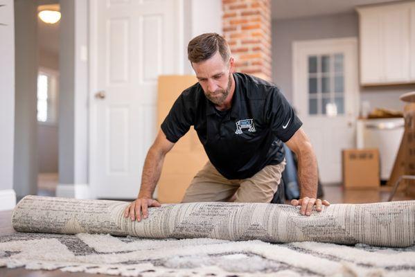 Rolling a rug tight is key for a one person lift