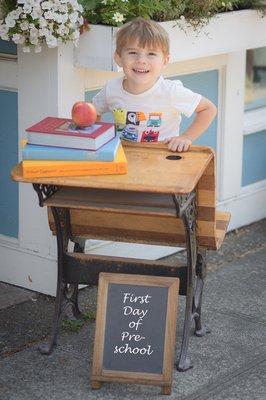 One of our first students, Ozzy, posing outside of QA Kids. We love QAKS!