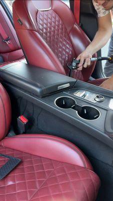 The center console area appears slightly dirty, especially around the cup holders.