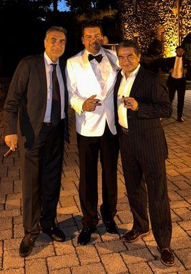 White custom tuxedo jacket, hand-tied bow, shirt and tuxedo pants, plus red bottom shoes