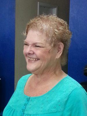 Gail has kinky curly hair so we cut it short colored it and taught her to use product in her hair