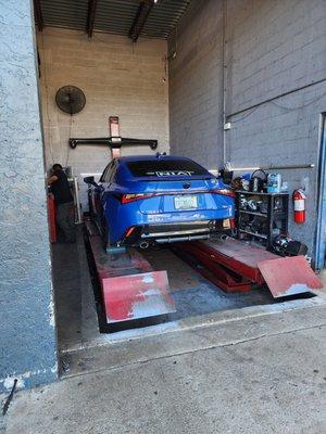 Lexus IS 350 F sport on lift for alignment
