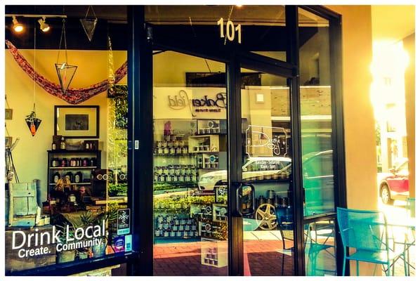 Store front with beautiful items for sale to pretty your home. Outside tables to drink your tasty beverages served there.