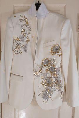 Gem stones were displaced throughout the jacket; and stain wasn't removed. Moreover, additional stains were on jacket upon pick up.