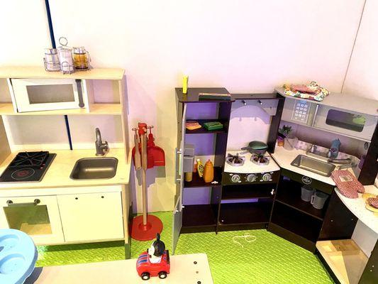Kitchen with very few food and cooking toys