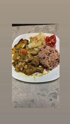 Curry chicken rice and peas with plantain and steamed veggie..