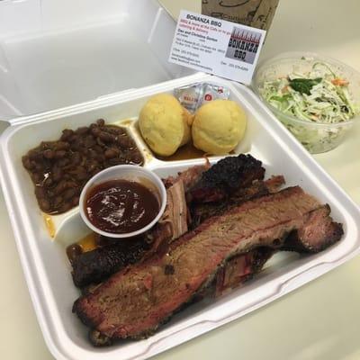 BBQ brisket plate with baked beans, coleslaw, and corn bread