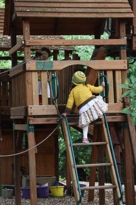 Children playing on the play structure in our oak forest!