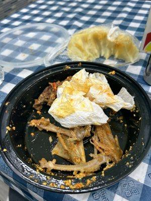 A finished plate of mixed meats with egusi and pounded yam.