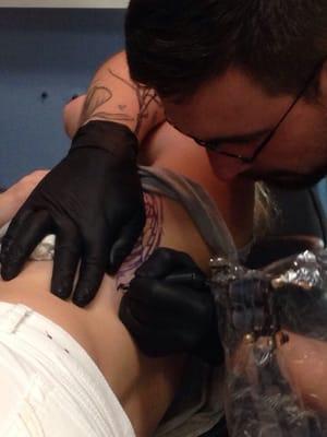 Tate Maynard-Dean working on the tattoo