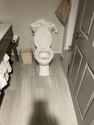 Crumpled towel on toilet tank