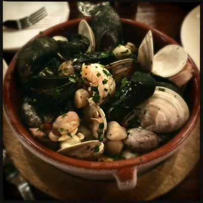 Mariscada salsa verde - seafood stew (clams, mussels, shrimp, scallops) in green sauce, with Spanish saffron risotto