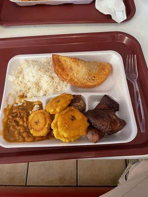Rice, habichuelas, tostones, pork, empanada