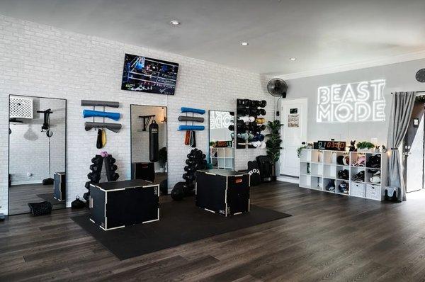 This is the main training space . Fully equipped with dumbbells, yoga matts, resistance bands , heavy bags , speed bag, and boxing ring.