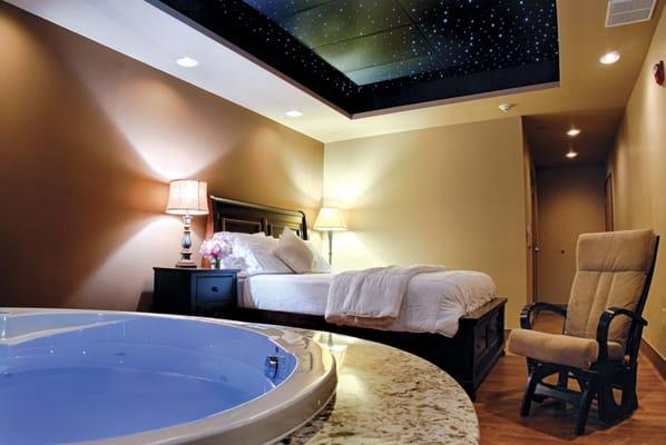 One of our beautiful birthing suites, Serenity, with a round, fully-accessorized tub.