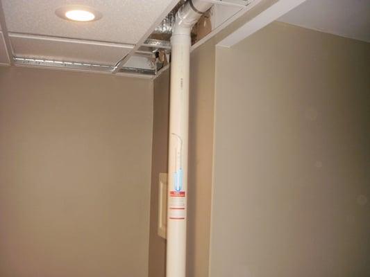 In many basement homes, PVC piping can be installed above drop ceilings to keep system hidden from view.