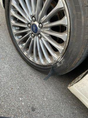 A ripped brand new tire and a very scratched up rim.