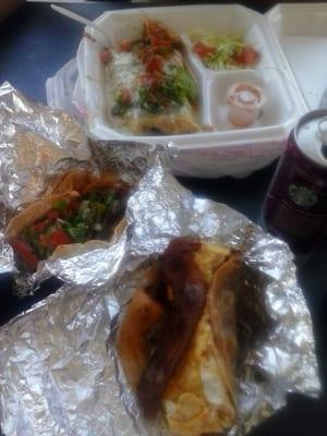 Huge burrito, yummmy brisket taco, and a chorizo and pepper mix w 2 eggs on top and slice of bacon on a flour tortilla.