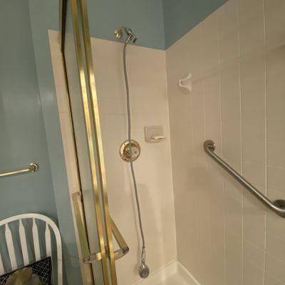 BEFORE: Old ugly shower stall with brass. Bye bye!