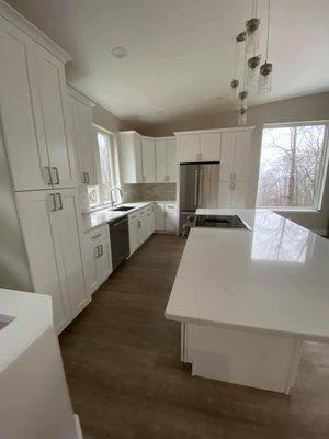 White shaker cabinets with the quartz countertops