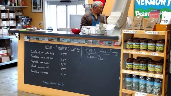 Menu board at counter inside market.