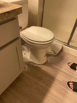 Clogged toilet from other bathroom pushing up into this bathroom via an unsecured toilet