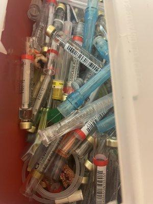 TOOTH IN CONTAINER ON COUNTER NEXT TO "CLEAN GLOVES AND UTENSILS"