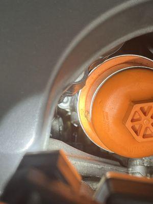 Oil leak just left bottom side of the orange car part.