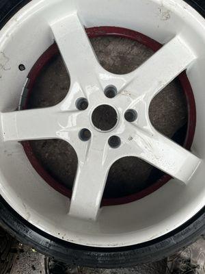 20" rim, custom white and red. Damaged paint due to tire balancing machine.